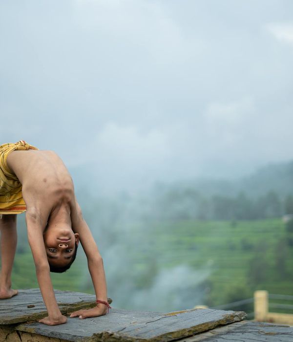 Woman practicing yoga outdoors in a serene natural setting.